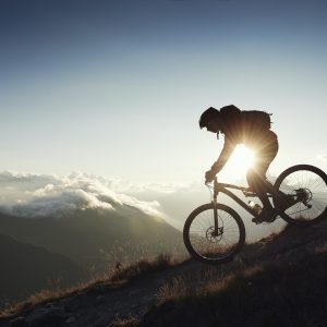 Mountain biker riding downhill, Valais, Switzerland